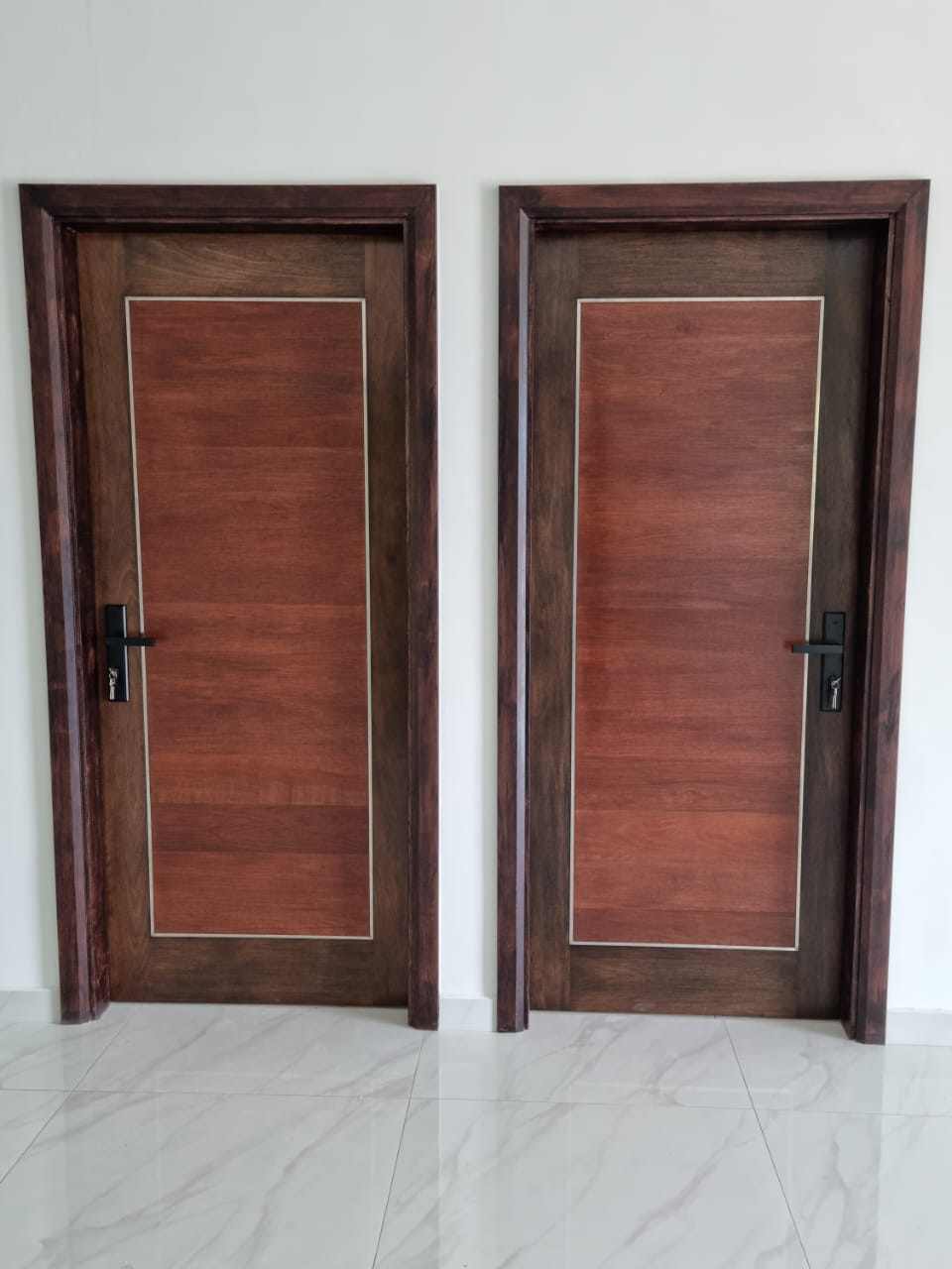 Pair of custom wooden room doors with inlay trim